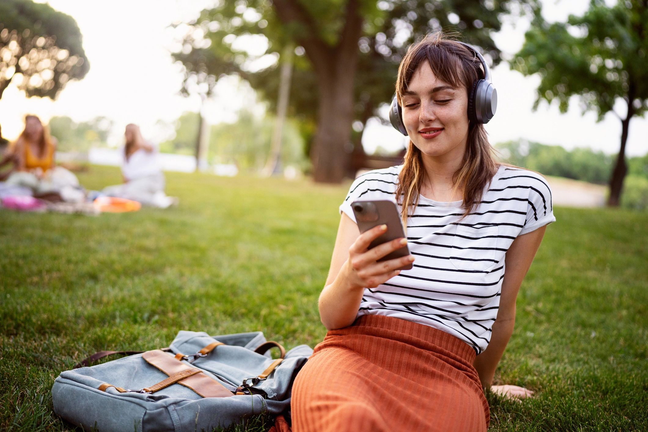 Listener using a phone with headphones